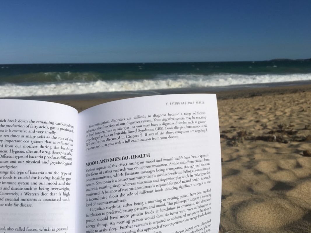 Reading Eating for You at the beach